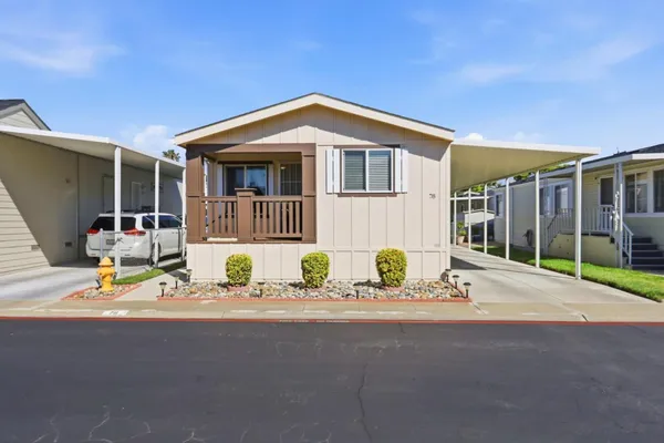 a front view of a house with a sitting area