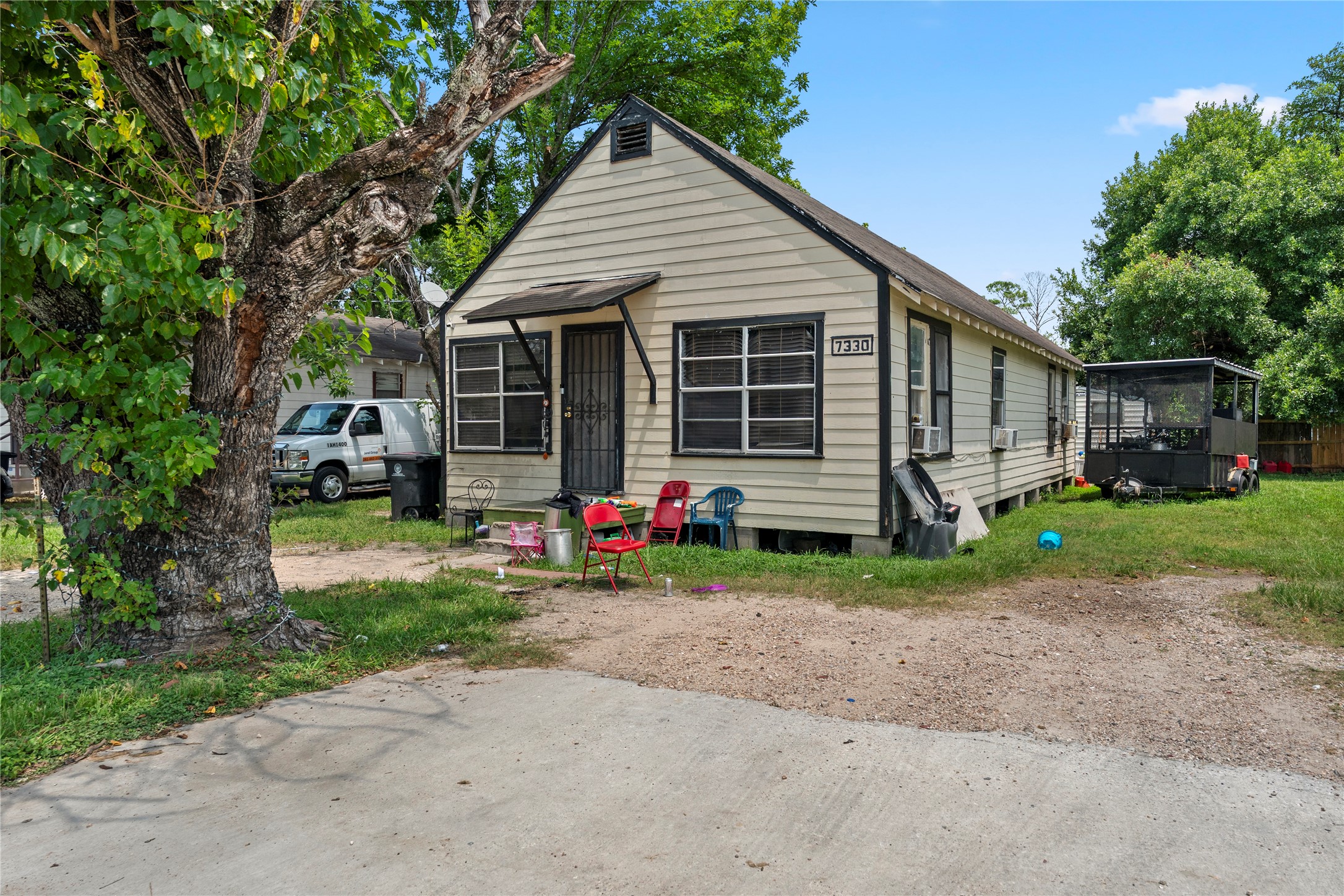 7330 Parkes Street Houston, TX 77088 - Photo 2 of 4 a view of a house with a small yard and a large tree