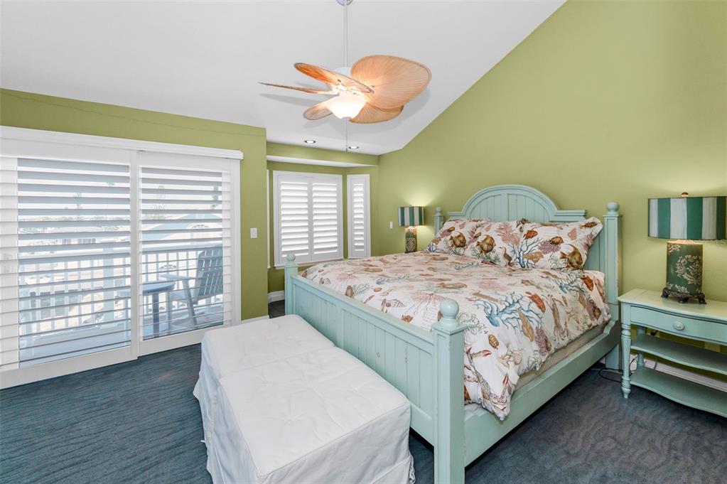 13303 Gulf Lane Madeira Beach, FL 33708 - Photo 22 of 42 a bedroom with a bed and a large window