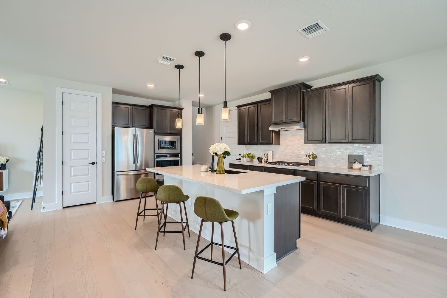 8319 Laughlin Lane Austin, TX 78744 - Photo 9 of 26 The kitchen is complete with a large island with quartz countertops and plenty of space for meal prep and casual dining.