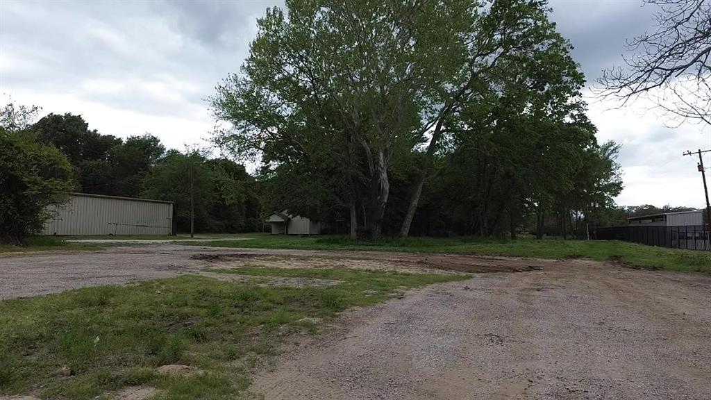 3110 West Gentry Parkway Tyler, TX 75702 - Photo 20 of 34 a view of dirt field with large trees