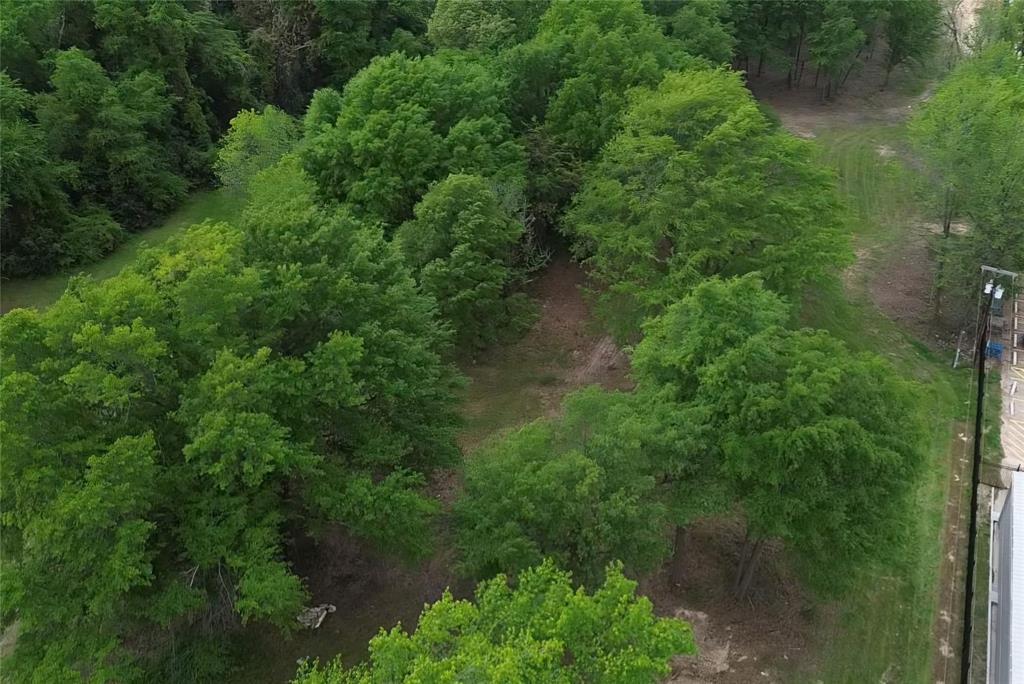 3110 West Gentry Parkway Tyler, TX 75702 - Photo 31 of 34 an aerial view of residential house with outdoor space and trees all around