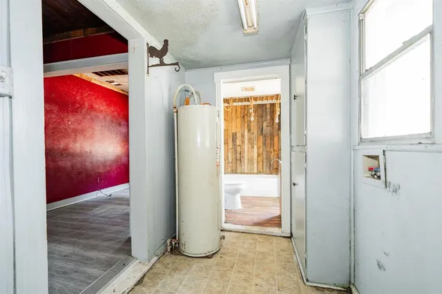 a view of a hallway with wooden floor and windows