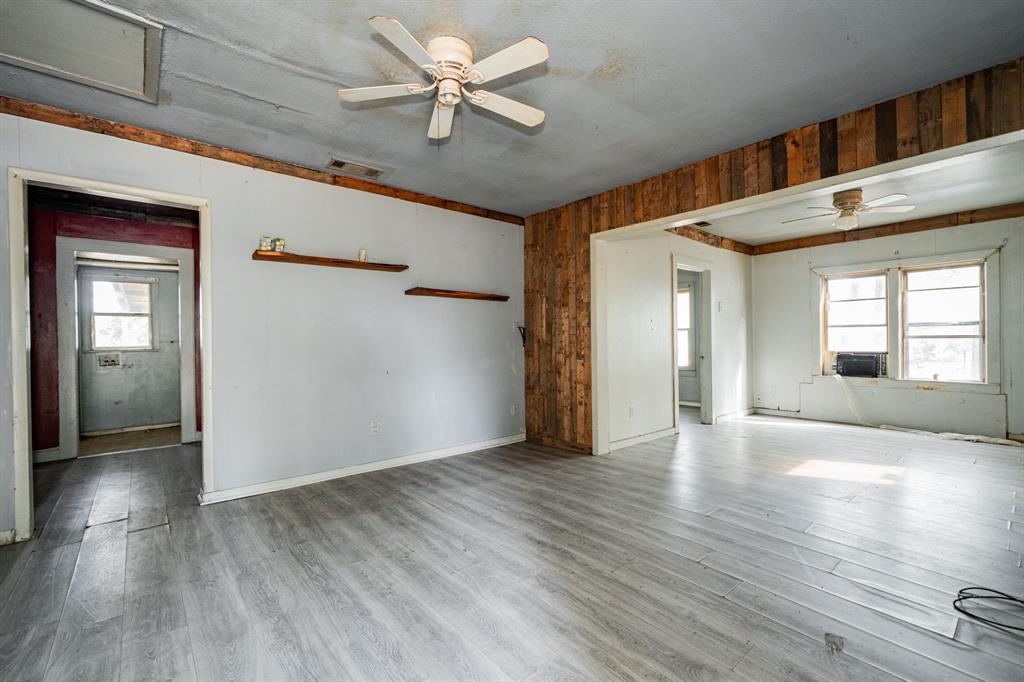 113 South Spikes Road Corsicana, TX 75110 - Photo 4 of 19 a view of an empty room with wooden floor and a window
