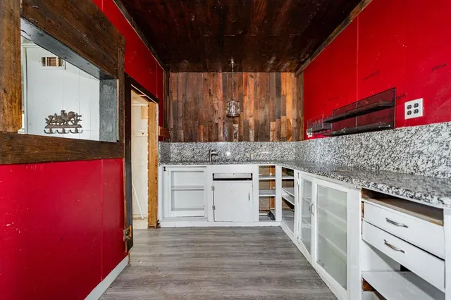 a kitchen with stainless steel appliances granite countertop a stove and cabinets