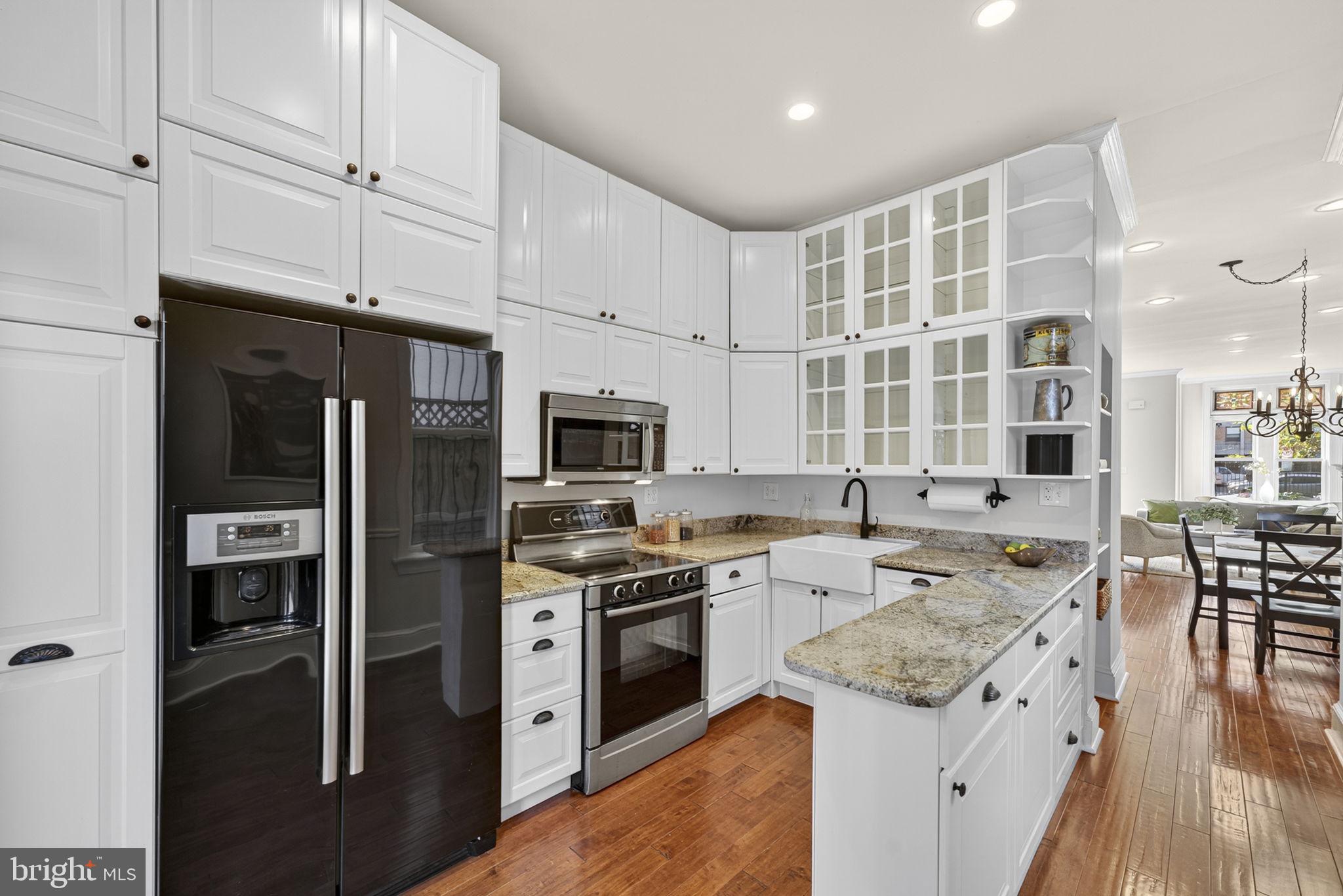 1218 G Street Southeast Washington, DC 20003 - Photo 11 of 37 a kitchen with a stove a sink and a refrigerator