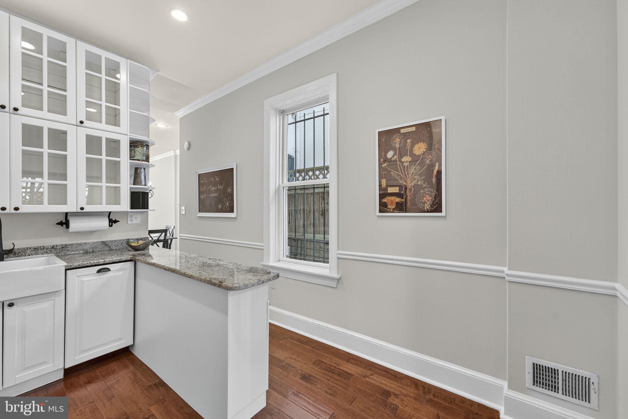 1218 G Street Southeast Washington, DC 20003 - Photo 13 of 37 a kitchen with granite countertop cabinets stainless steel appliances and a sink