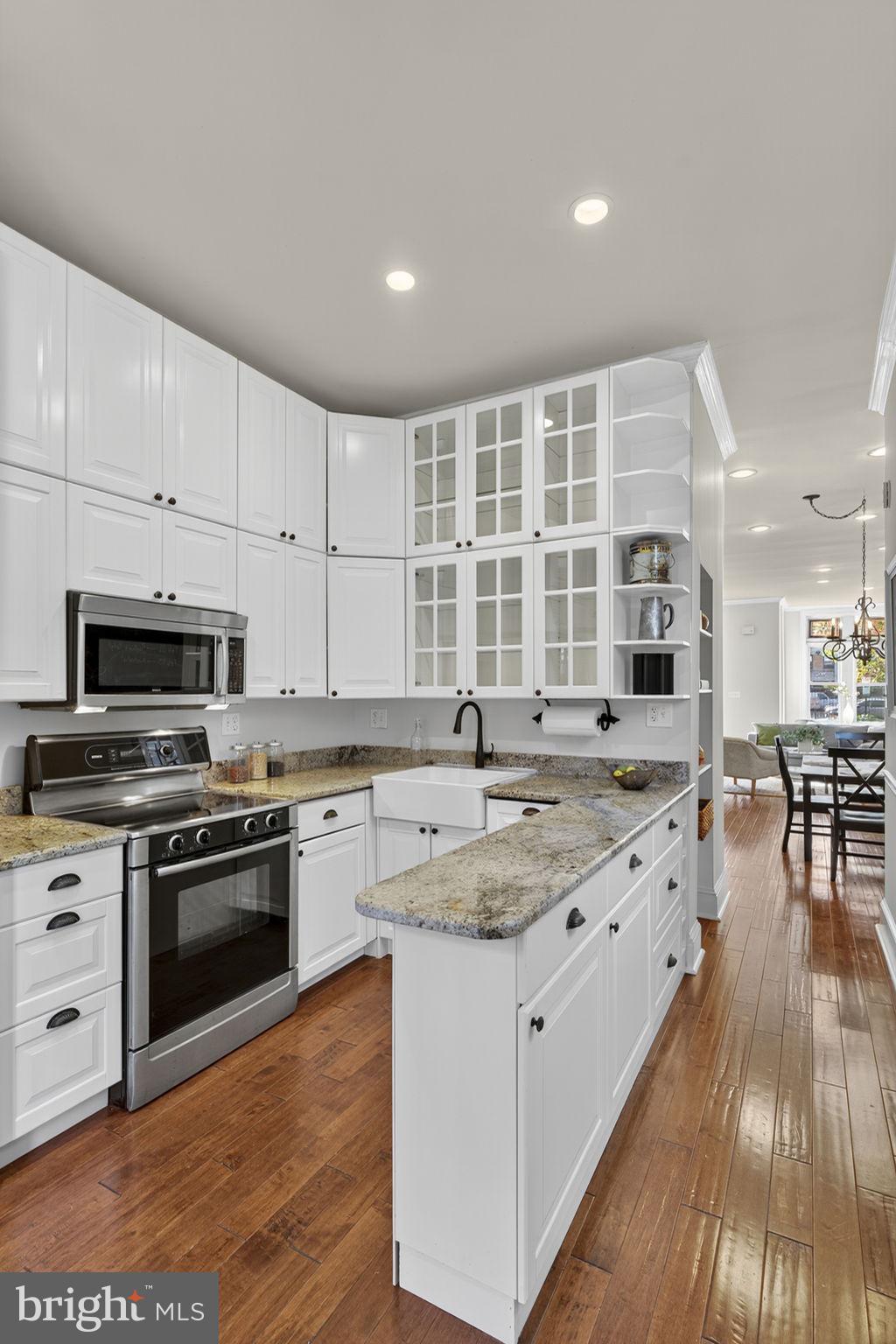 1218 G Street Southeast Washington, DC 20003 - Photo 19 of 37 a kitchen with stainless steel appliances granite countertop a stove and cabinets