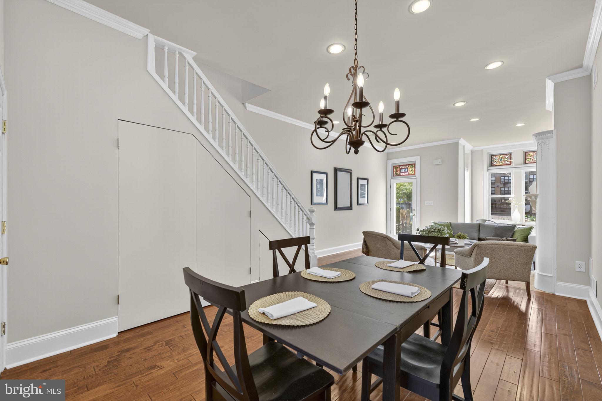 1218 G Street Southeast Washington, DC 20003 - Photo 21 of 37 a view of a dining room with furniture a chandelier and wooden floor