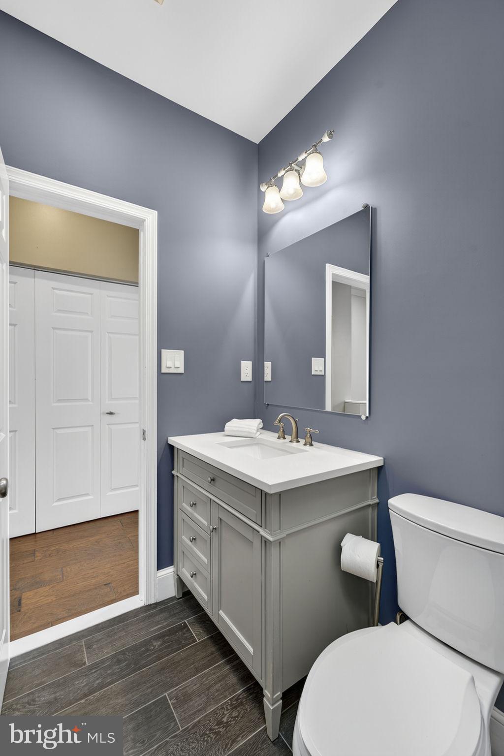 1218 G Street Southeast Washington, DC 20003 - Photo 32 of 37 a bathroom with a toilet sink and mirror