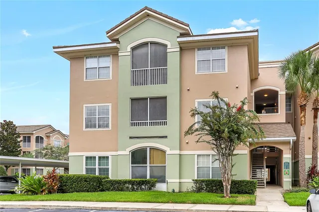 a front view of residential houses with yard and green space