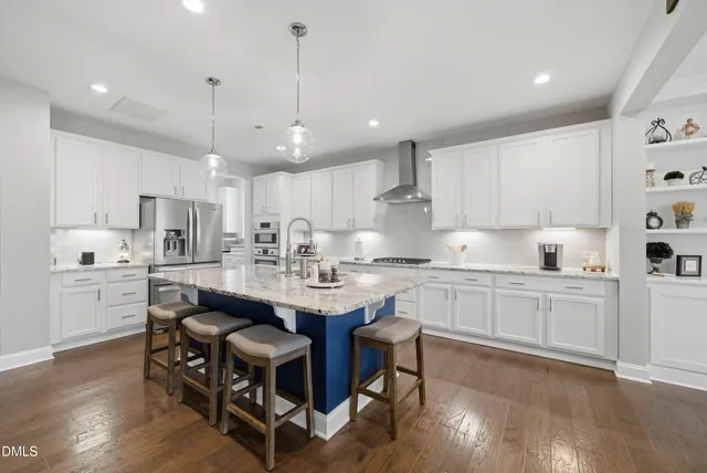 a kitchen with kitchen island granite countertop a sink a center island and cabinets