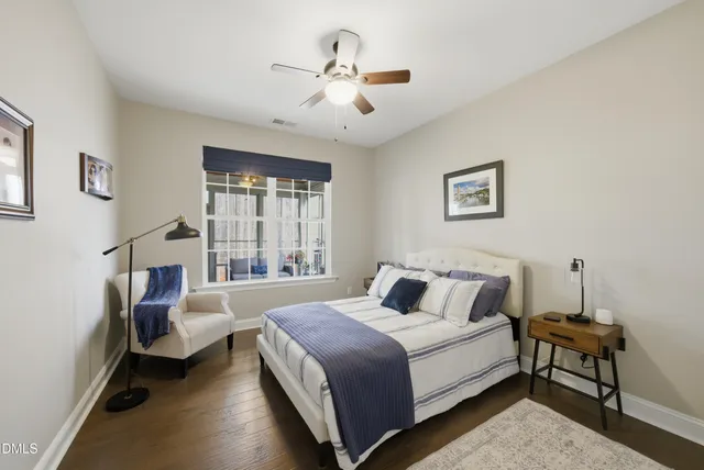 a bedroom with a large bed and a chandelier