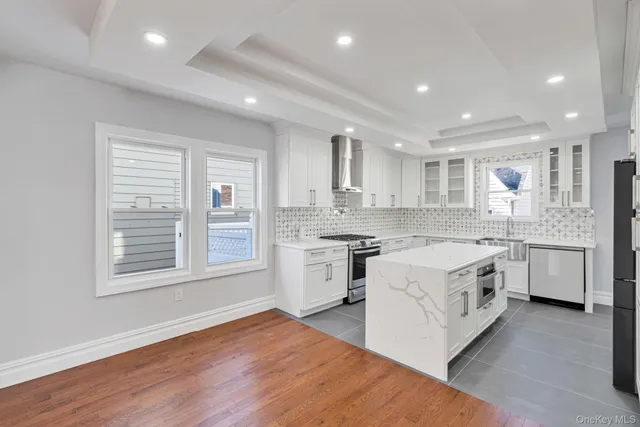 a large kitchen with stainless steel appliances granite countertop a stove and a sink