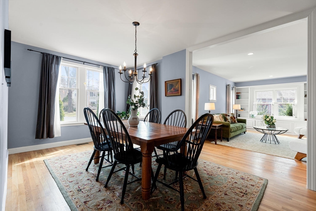 56 Grapevine Avenue Lexington, MA 02421 - Photo 11 of 38 a view of a dining room and livingroom with furniture wooden floor a chandelier