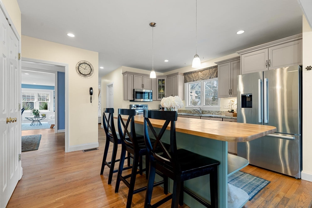 56 Grapevine Avenue Lexington, MA 02421 - Photo 14 of 38 a dining area with stainless steel appliances kitchen island granite countertop a dining table chairs and granite counter tops