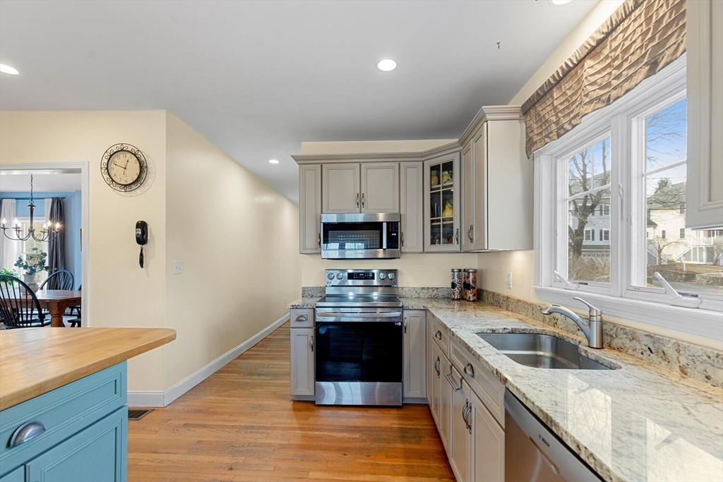 56 Grapevine Avenue Lexington, MA 02421 - Photo 15 of 38 a kitchen with stainless steel appliances granite countertop a sink stove and refrigerator