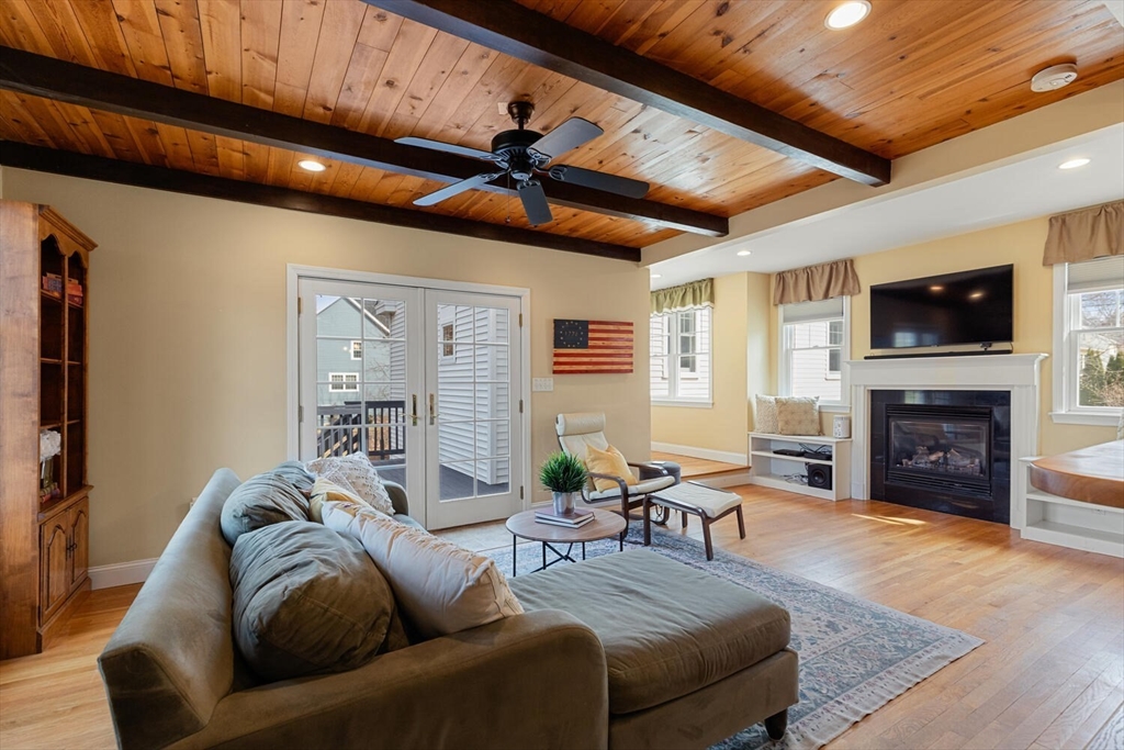 56 Grapevine Avenue Lexington, MA 02421 - Photo 18 of 38 a living room with furniture a fireplace and a flat screen tv