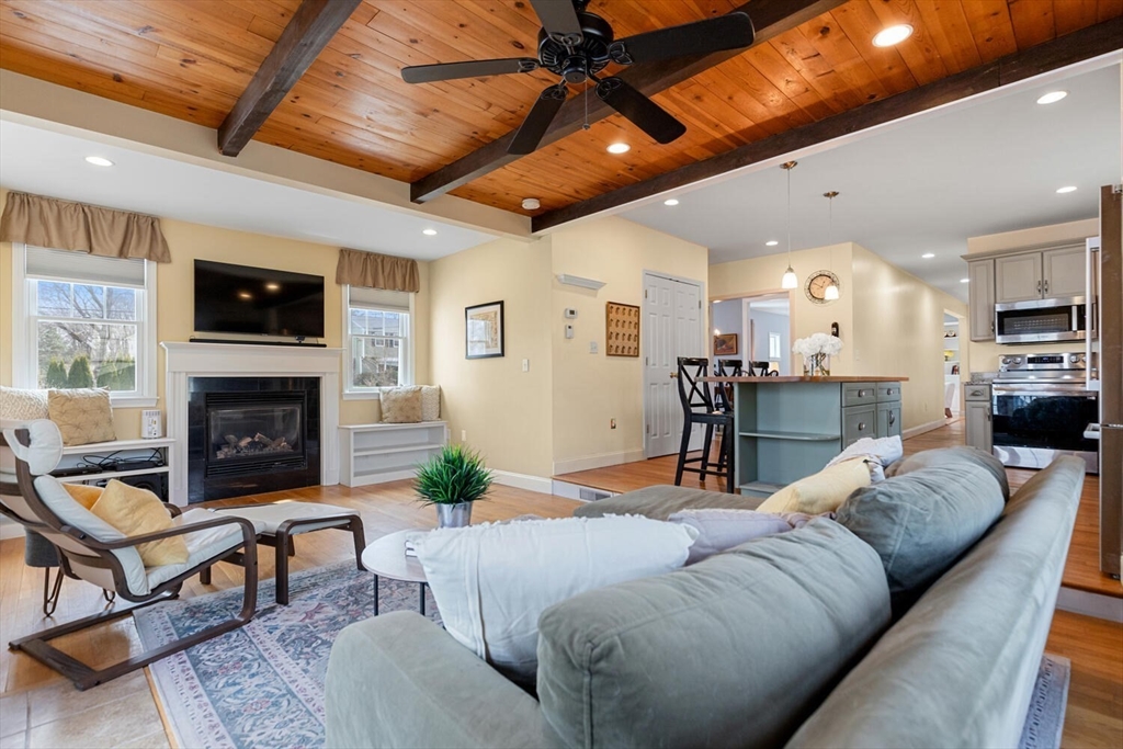 56 Grapevine Avenue Lexington, MA 02421 - Photo 19 of 38 a living room with furniture kitchen view and a fireplace