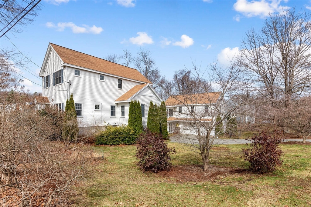 56 Grapevine Avenue Lexington, MA 02421 - Photo 2 of 38 a backyard of a house with lots of green space