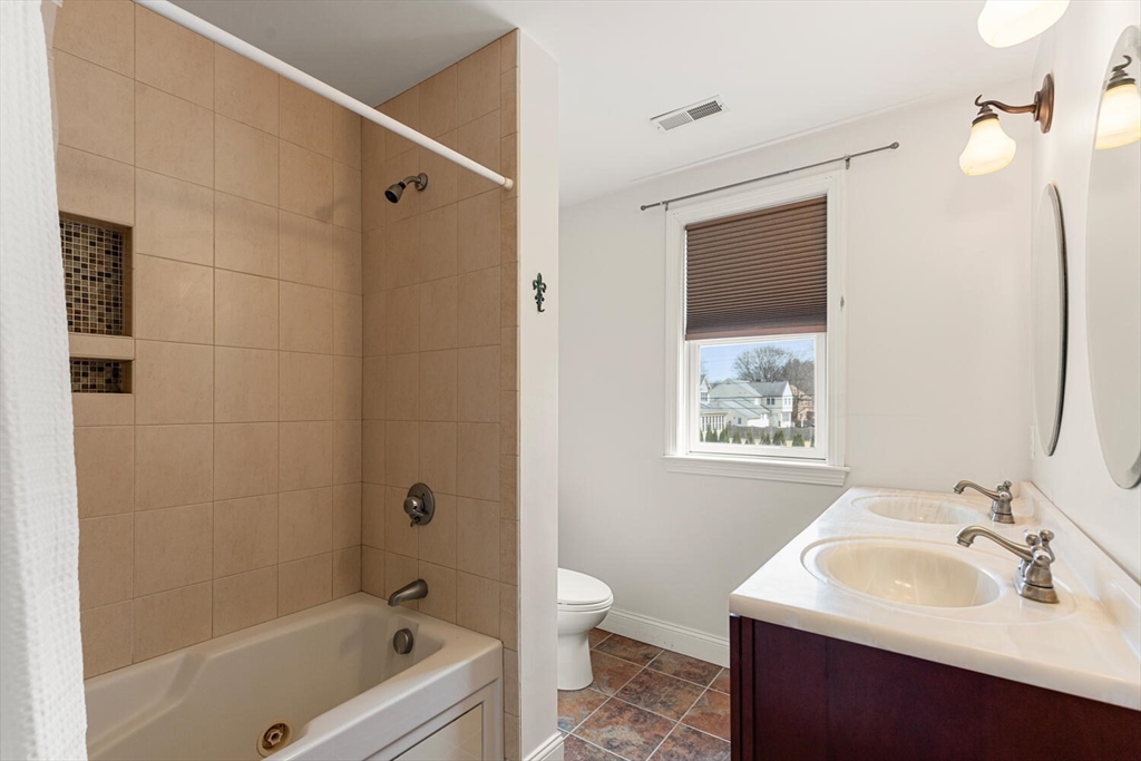 56 Grapevine Avenue Lexington, MA 02421 - Photo 26 of 38 a bathroom with a sink a toilet and shower