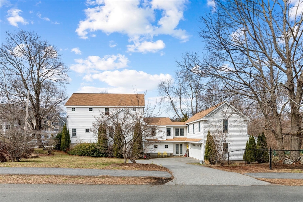 56 Grapevine Avenue Lexington, MA 02421 - Photo 4 of 38 a view of a white house next to a road and yard
