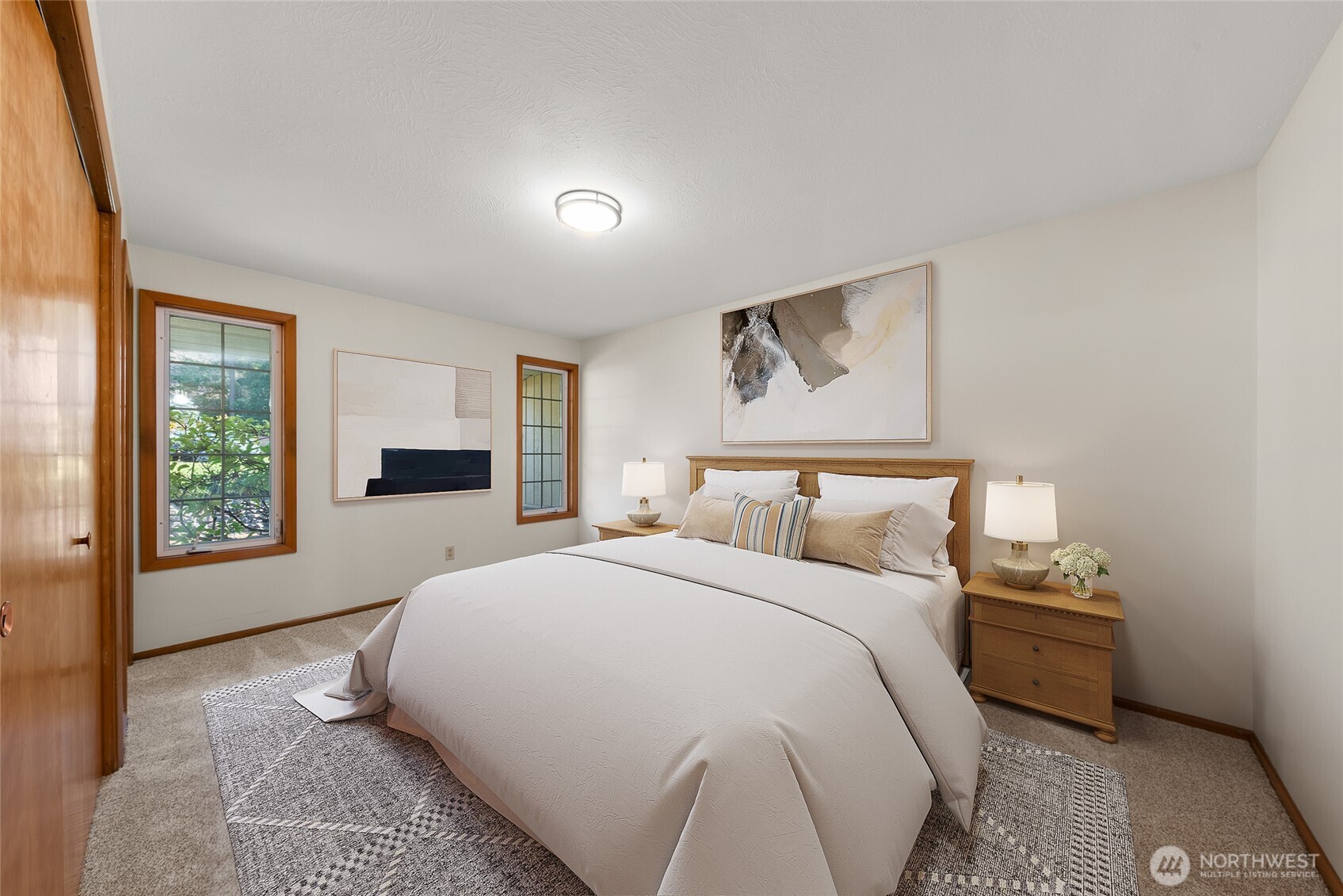 2811 West Weile Avenue Spokane, WA 99208 - Photo 15 of 39 a spacious bedroom with a bed and wooden floor