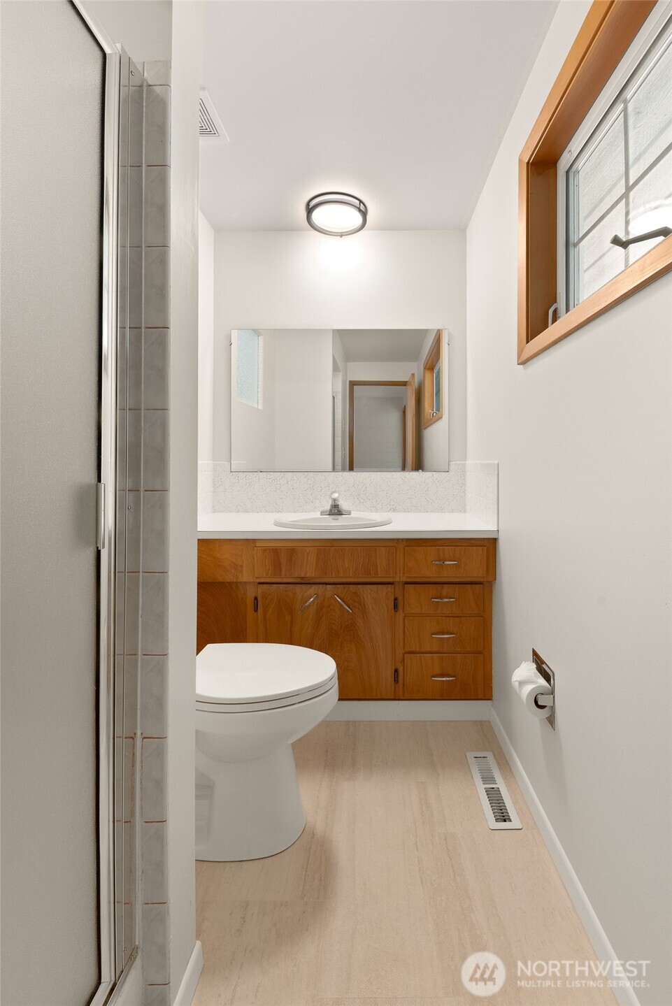 2811 West Weile Avenue Spokane, WA 99208 - Photo 17 of 39 a bathroom with a toilet sink and mirror