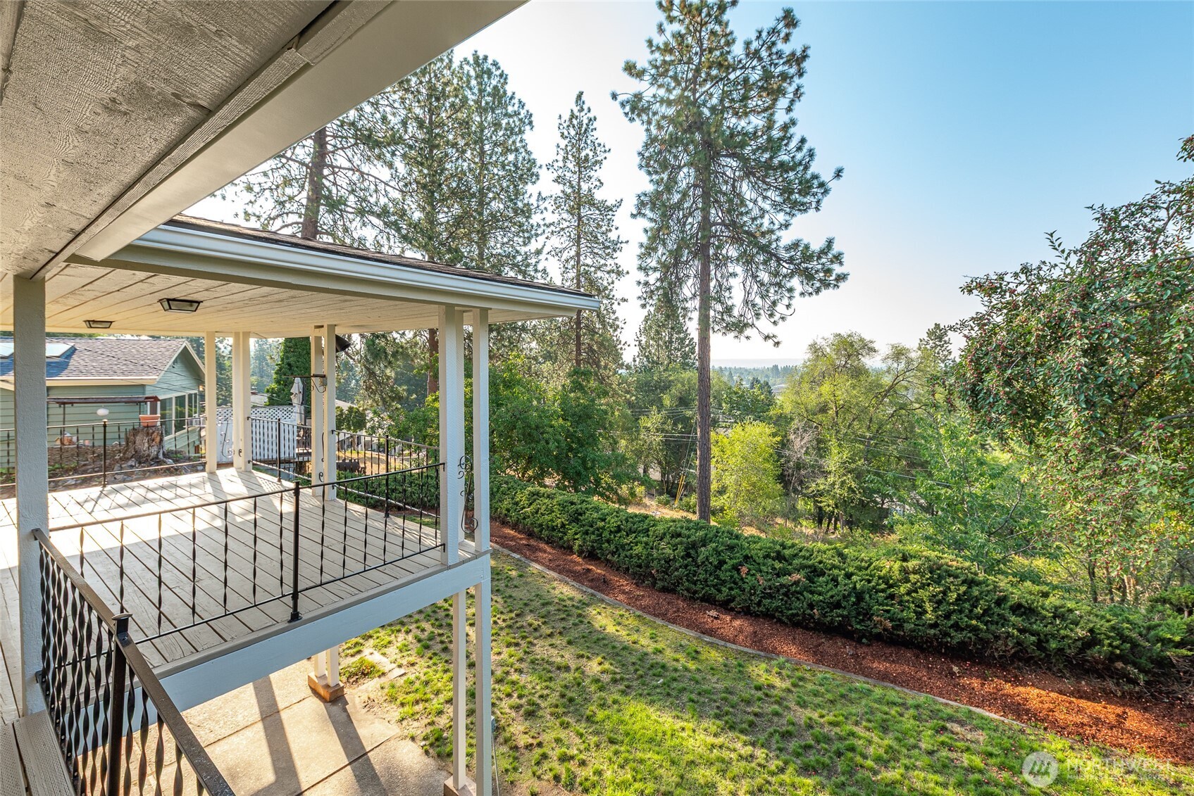 2811 West Weile Avenue Spokane, WA 99208 - Photo 3 of 39 a view of backyard with large trees and plants