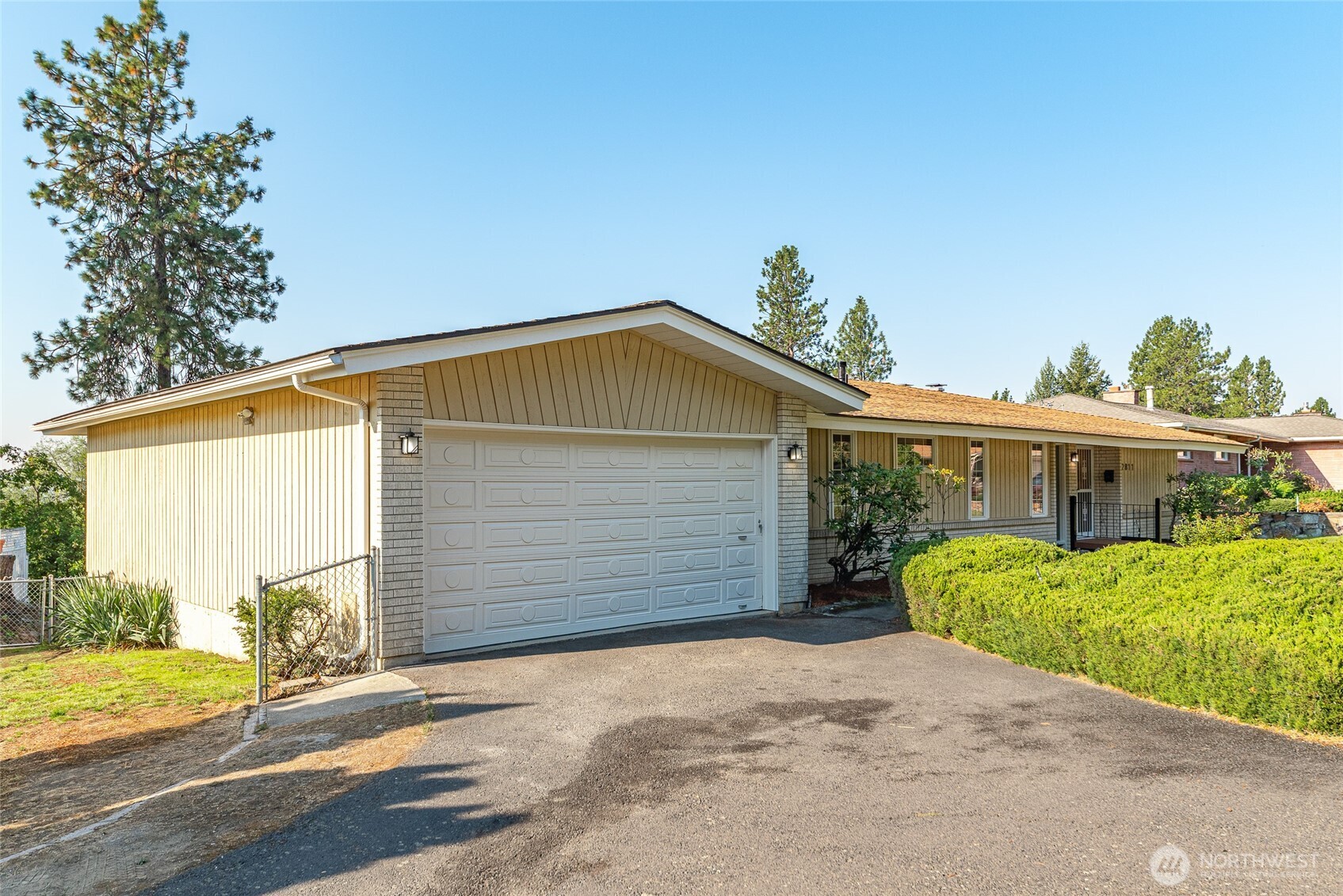 2811 West Weile Avenue Spokane, WA 99208 - Photo 37 of 39 a front view of a house with a yard and garage