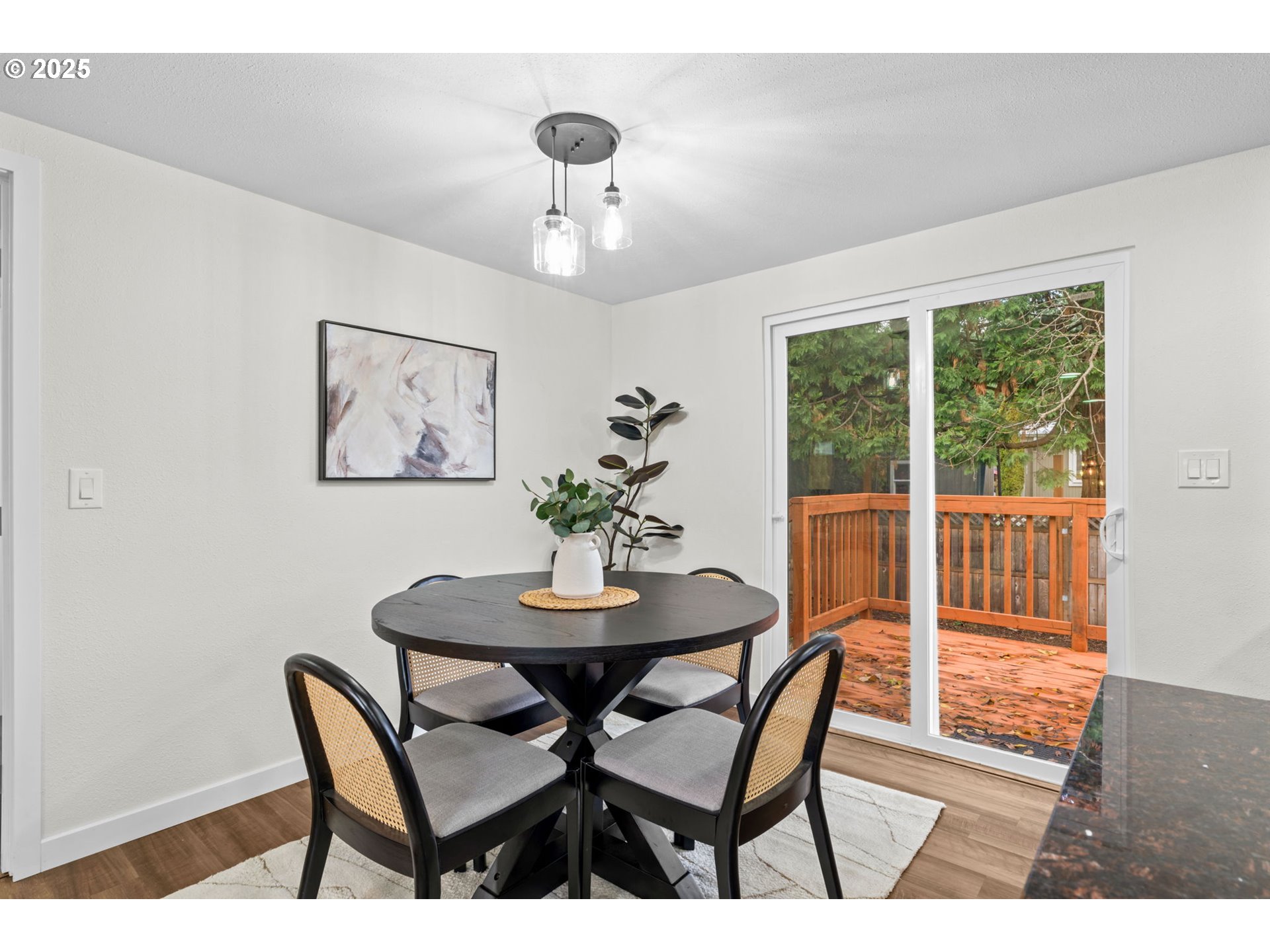 27645 Snyder Road Junction City, OR 97448 - Photo 13 of 41 a view of a dining room with furniture window and wooden floor