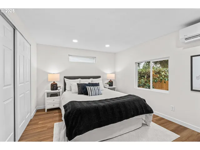 a bedroom with a bed and a large window