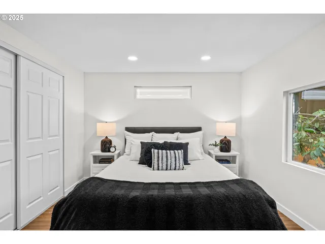 a bedroom with a bed and a window