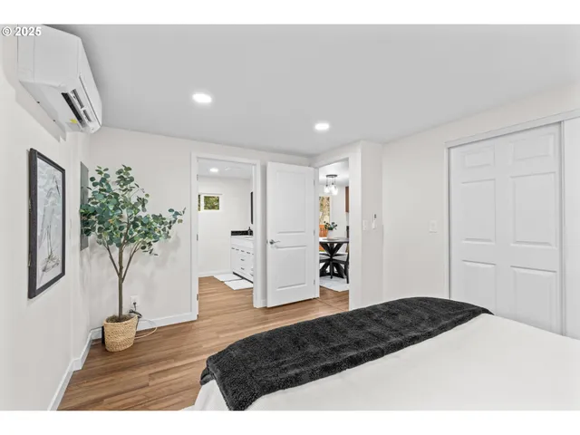 a bedroom with a bed and a potted plant