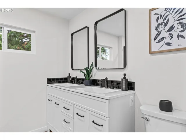 a bathroom with a sink vanity and mirror