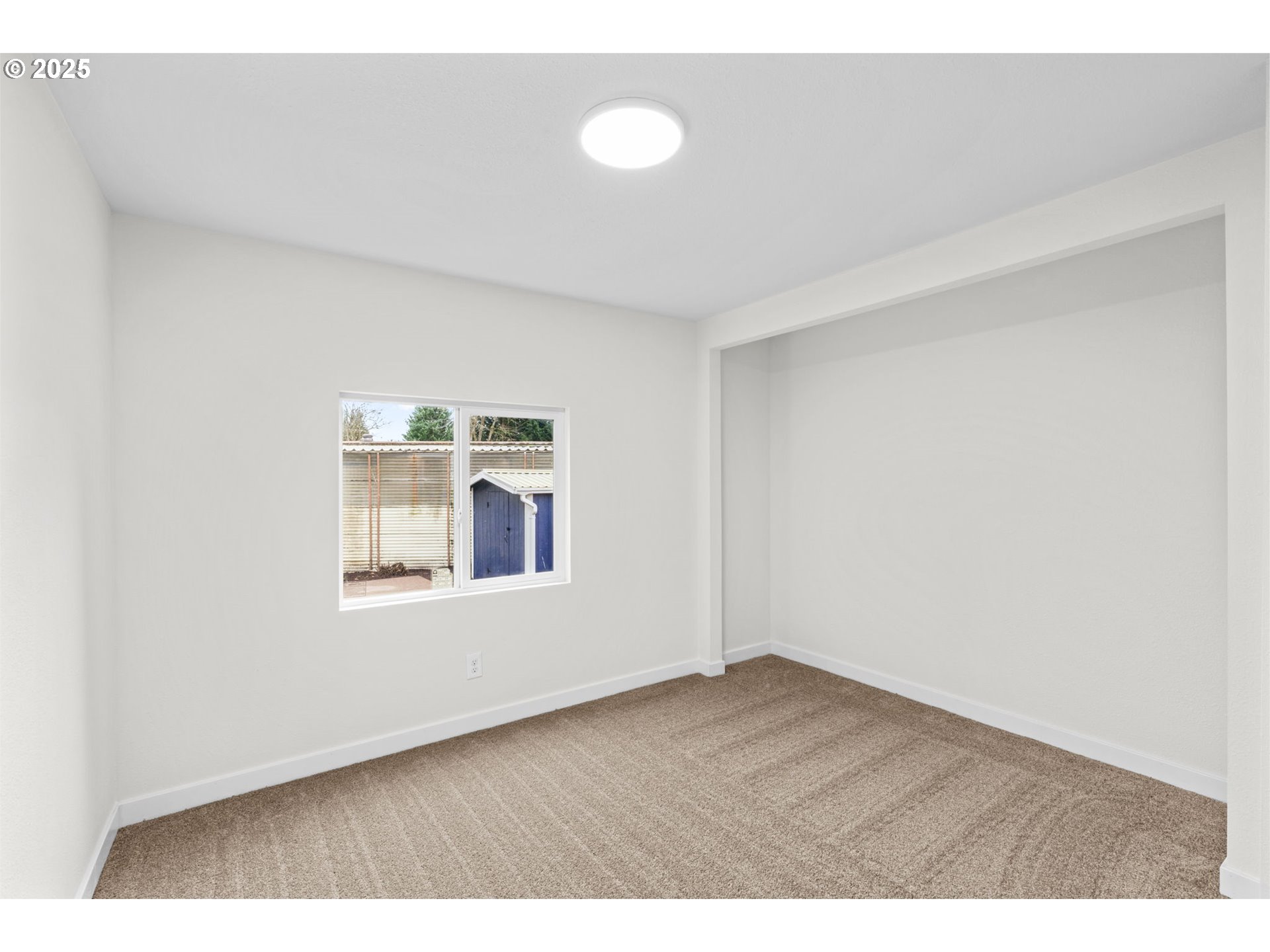 27645 Snyder Road Junction City, OR 97448 - Photo 26 of 41 a view of an empty room with wooden floor and a window
