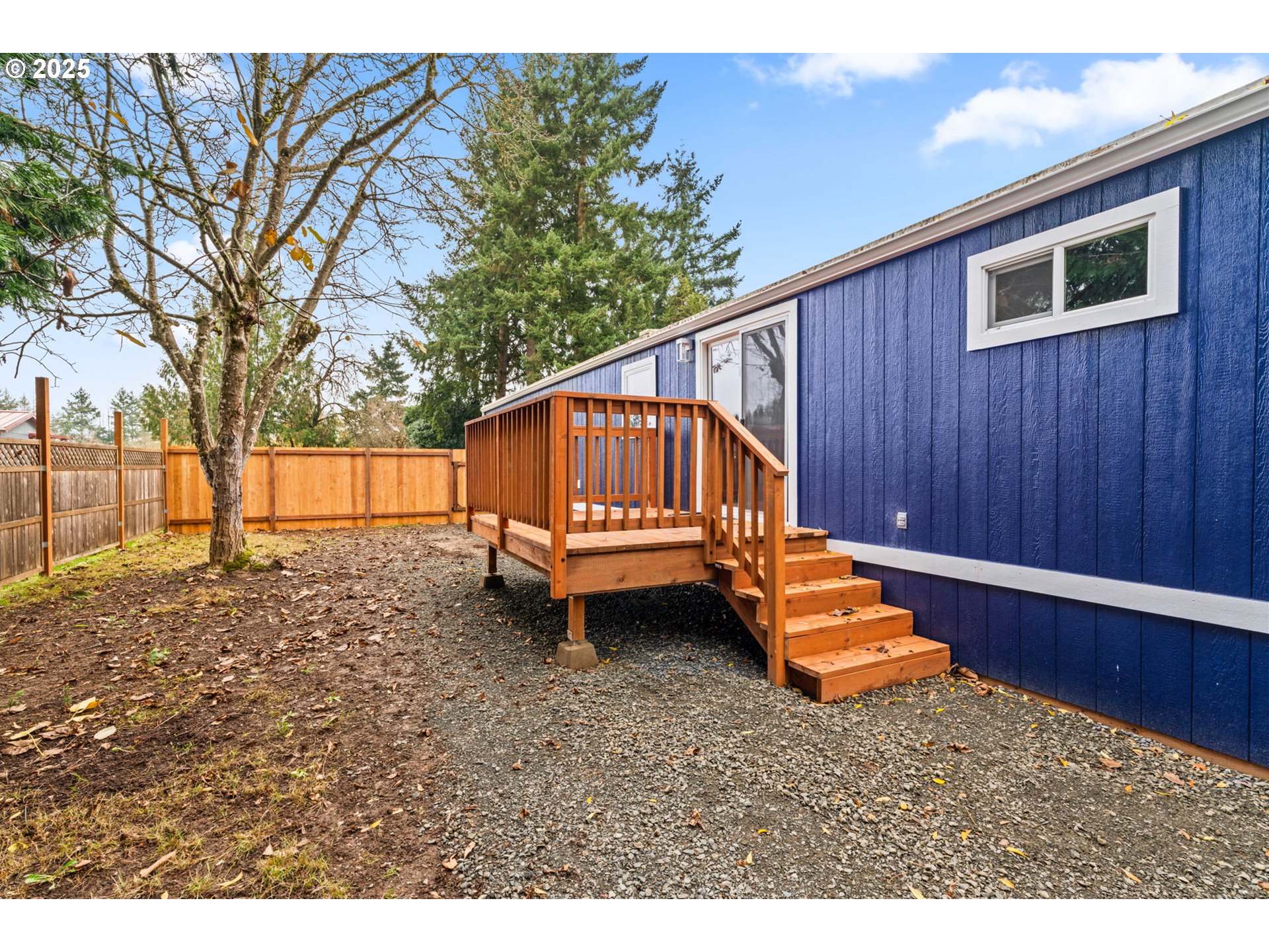 27645 Snyder Road Junction City, OR 97448 - Photo 34 of 41 a backyard of a house with wooden fence and trees