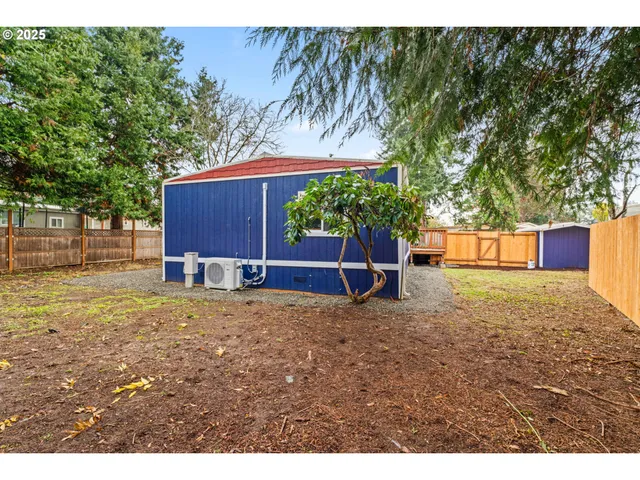 a backyard of a house with a yard and outdoor seating