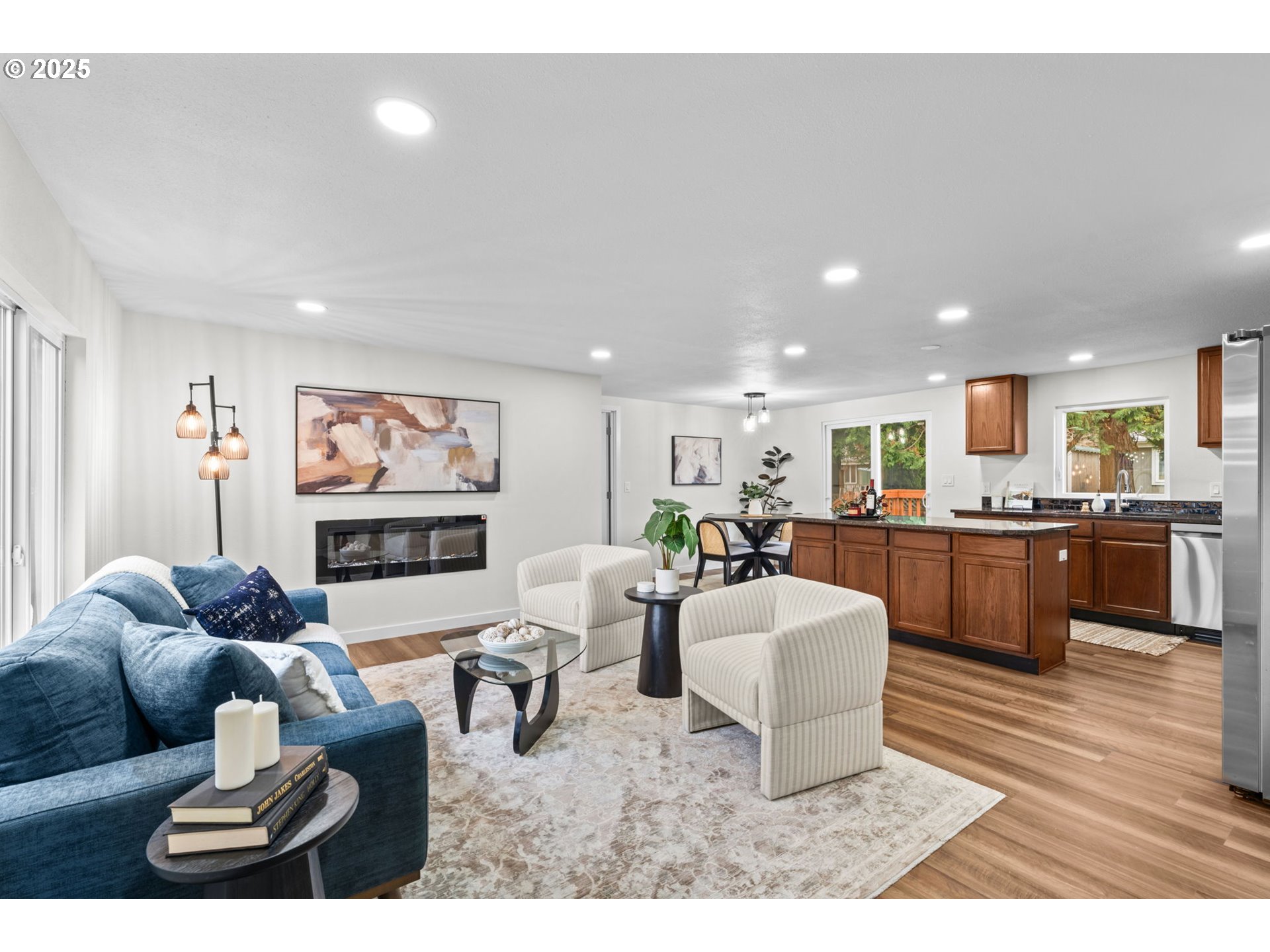 27645 Snyder Road Junction City, OR 97448 - Photo 6 of 41 a living room with furniture a kitchen view and a wooden floor