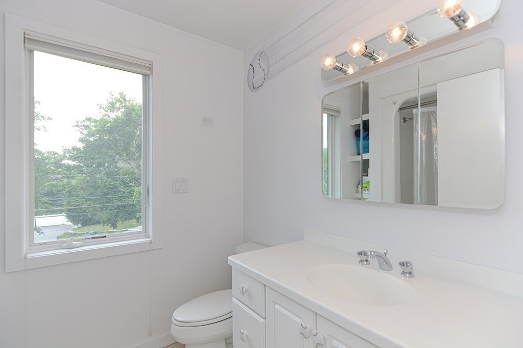 14 Columbine Road Newton, MA 02459 - Photo 25 of 36 a bathroom with a sink a toilet and a mirror