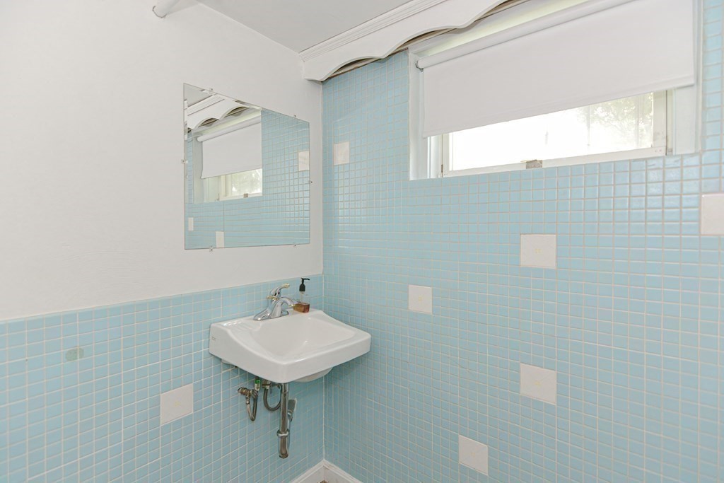 14 Columbine Road Newton, MA 02459 - Photo 27 of 36 a bathroom with a sink a mirror and a toilet