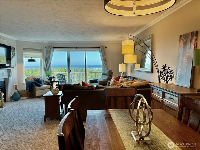 a view of a dining room with furniture and chandelier
