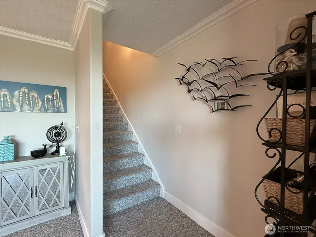 a view of a hallway with wooden floor and closet