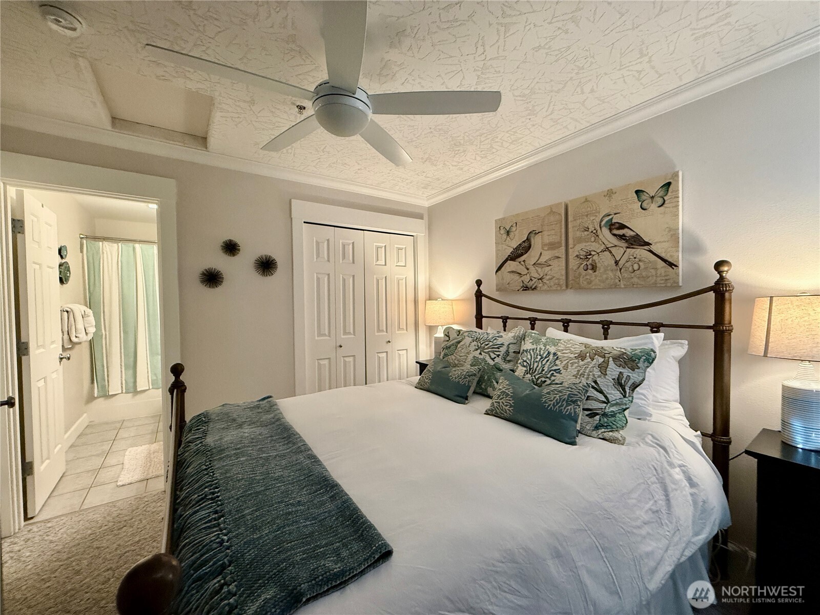 2815 Willows Road, Unit 210 Seaview, WA 98644 - Photo 28 of 35 a bedroom with a bed and a chandelier