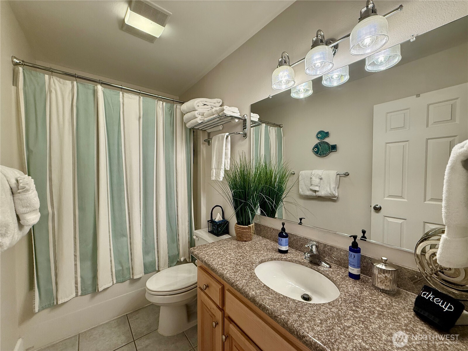 2815 Willows Road, Unit 210 Seaview, WA 98644 - Photo 29 of 35 a bathroom with a granite countertop sink a toilet and a mirror
