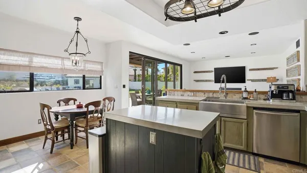 a kitchen with stainless steel appliances kitchen island granite countertop a sink and cabinets
