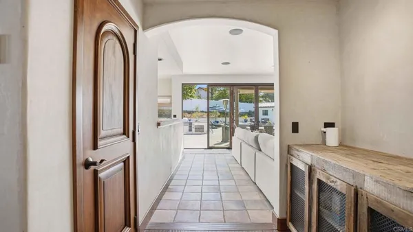 a view of a kitchen with a sink and refrigerator