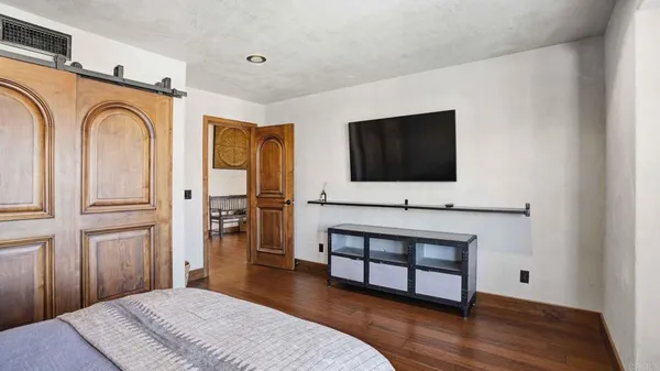 a bed sitting in a bedroom next to a window