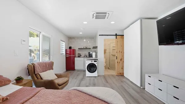 a kitchen with a sink a refrigerator and window