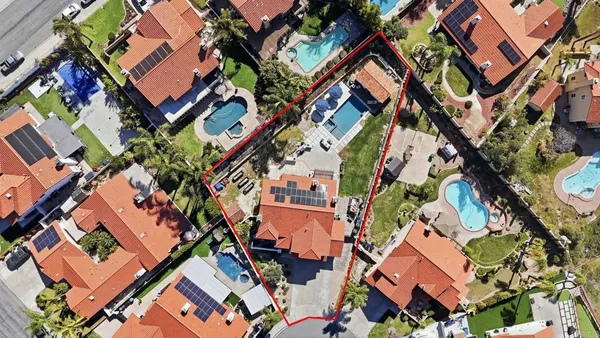 an aerial view of residential houses with outdoor space